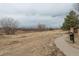 Scenic walking path through a beautiful community with lush landscaping and mature trees at 16191 E Hinsdale Ln, Aurora, CO 80016