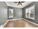 Bright bedroom with wood floors, plantation shutters, and ceiling fan at 14959 Wistera Way, Broomfield, CO 80023