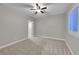 Well-lit bedroom with ceiling fan and access to another room at 14959 Wistera Way, Broomfield, CO 80023