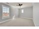 Bright bedroom featuring a window with plantation shutters and ceiling fan at 14959 Wistera Way, Broomfield, CO 80023