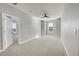 Spacious bedroom with carpeted floor, ceiling fan, and large window at 14959 Wistera Way, Broomfield, CO 80023