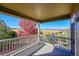 Deck with mountain views and a beautiful tree in autumn at 14959 Wistera Way, Broomfield, CO 80023