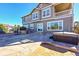 Two-story home with large windows and stone patio at 14959 Wistera Way, Broomfield, CO 80023