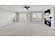 Spacious living room showcasing a fireplace, carpet, and large windows at 14959 Wistera Way, Broomfield, CO 80023