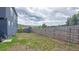 Backyard featuring wooden fence, grassy area, and views of trees at 260 Upper Glenway Rd, Palmer Lake, CO 80133