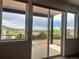 From inside looking out to the balcony area with scenic neighborhood and partial mountain views at 260 Upper Glenway Rd, Palmer Lake, CO 80133