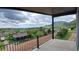 Covered balcony offers scenic views of a charming neighborhood and picturesque mountains in the distance at 260 Upper Glenway Rd, Palmer Lake, CO 80133