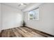 Bright bedroom with modern ceiling fan, hardwood floors, and a large window offering lots of natural light at 260 Upper Glenway Rd, Palmer Lake, CO 80133