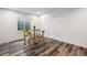 Cozy dining area features natural light, hardwood floors, and a four seat dining table at 260 Upper Glenway Rd, Palmer Lake, CO 80133