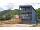 Modern two-story home with sleek balconies, gray exterior, and mountain views at 260 Upper Glenway Rd, Palmer Lake, CO 80133