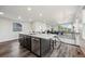 Kitchen island with marble countertop and seating adjacent to open living space at 260 Upper Glenway Rd, Palmer Lake, CO 80133