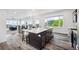 Open-concept kitchen island with seating and views of lush greenery and mountains at 260 Upper Glenway Rd, Palmer Lake, CO 80133