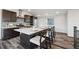 Stylish kitchen with large island, stainless steel appliances, and wood-look flooring at 260 Upper Glenway Rd, Palmer Lake, CO 80133