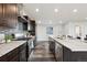 Modern kitchen featuring stainless steel appliances, dark wood cabinets, and marble countertops at 260 Upper Glenway Rd, Palmer Lake, CO 80133