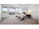 Bright main bedroom with sliding glass doors that lead to an outdoor balcony with neighborhood views at 260 Upper Glenway Rd, Palmer Lake, CO 80133