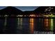 Captivating night view of a serene lake reflecting shimmering lights, creating a magical and tranquil atmosphere at 260 Upper Glenway Rd, Palmer Lake, CO 80133
