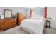 Calming bedroom features a plush bed, wooden dressers, neutral walls, and soft natural light at 4509 Everett St, Wheat Ridge, CO 80033