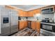 Updated kitchen with stainless steel appliances, wood cabinetry, and modern backsplash, a functional and stylish space at 4509 Everett St, Wheat Ridge, CO 80033