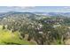 Panoramic aerial of a home nestled in a forest with mountain views beyond at 2023 Mammoth Ct, Evergreen, CO 80439
