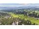 Expansive aerial view of an estate home and the surrounding lush, green community at 2023 Mammoth Ct, Evergreen, CO 80439
