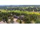 Stunning aerial view of estate home with lush green forest and mountain views at 2023 Mammoth Ct, Evergreen, CO 80439