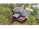 Aerial view of home featuring large deck area, mature trees, and well-maintained roof at 2023 Mammoth Ct, Evergreen, CO 80439