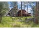 Back of house showing multilevel decks in wooded yard at 2023 Mammoth Ct, Evergreen, CO 80439