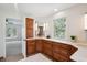 Spacious bathroom with custom wood cabinets, double sinks, and a view of mature trees at 2023 Mammoth Ct, Evergreen, CO 80439