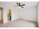 Large bedroom with an attached bathroom and a ceiling fan at 2023 Mammoth Ct, Evergreen, CO 80439
