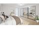 Cozy bedroom featuring a large closet, neutral carpet and adjacent ensuite entrance at 2023 Mammoth Ct, Evergreen, CO 80439