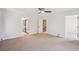 Spacious bedroom with neutral carpeting, ceiling fan, and multiple doorways leading to other areas of the home at 2023 Mammoth Ct, Evergreen, CO 80439