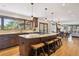 Open-concept kitchen with an island, seating, and a seamless connection to the dining and living spaces at 2023 Mammoth Ct, Evergreen, CO 80439