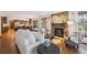 Inviting living room features a stone fireplace, hardwood floors, and an open layout connecting to the kitchen at 2023 Mammoth Ct, Evergreen, CO 80439