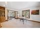Bright office space features a natural wood desk, built-in bookcase, and windows with views of the surrounding landscape at 2023 Mammoth Ct, Evergreen, CO 80439