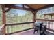 Outdoor deck with beautiful pine tree views featuring Traeger grill at 2023 Mammoth Ct, Evergreen, CO 80439