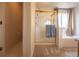 Bright bathroom featuring a glass shower and a soaking tub with neutral walls and carpet at 475 Hampstead Ave, Castle Rock, CO 80104