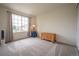 Neutral bedroom featuring a large window with curtains and a light-colored carpet at 475 Hampstead Ave, Castle Rock, CO 80104