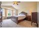 The main bedroom features a luxurious bed, neutral walls, and a large window at 475 Hampstead Ave, Castle Rock, CO 80104