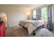 Cozy bedroom featuring a plush bed with patterned bedding, mirror and carpet at 475 Hampstead Ave, Castle Rock, CO 80104