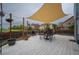 Cozy outdoor deck with a table and chairs beneath a canvas shade, ideal for relaxing or dining al fresco at 475 Hampstead Ave, Castle Rock, CO 80104