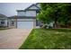 Traditional two-story home with a well-manicured lawn, mature tree, and attached garage at 475 Hampstead Ave, Castle Rock, CO 80104