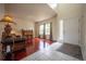 Inviting foyer with a combination of hardwood and tile flooring, large windows, and a view into the spacious living room at 475 Hampstead Ave, Castle Rock, CO 80104