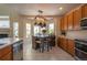 Charming kitchen with a dining nook, stainless steel appliances, and plenty of natural light filtering through bay windows at 475 Hampstead Ave, Castle Rock, CO 80104