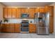 Modern kitchen featuring stainless steel appliances, light wood cabinets, and ample countertop space for food preparation at 475 Hampstead Ave, Castle Rock, CO 80104