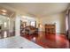 An open concept living room featuring beautiful hardwood floors and stylish furniture, with a view into the dining area at 475 Hampstead Ave, Castle Rock, CO 80104