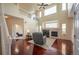 Bright living room with a fireplace, large windows, hardwood floors, and a view to an office at 475 Hampstead Ave, Castle Rock, CO 80104