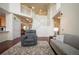 Open living room with a cozy fireplace, hardwood floors, a staircase, and neutral colored furniture at 475 Hampstead Ave, Castle Rock, CO 80104