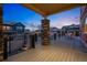 Cozy covered back porch with stone pillar, steel cable railing, and backyard views at 336 Painted Horse Way, Erie, CO 80516