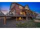 Stunning view of the backyard deck and patio space with seating, stairs, and lush landscaping at 336 Painted Horse Way, Erie, CO 80516
