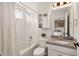 Cozy bathroom features a shower-tub combination with bright white tile and a granite-topped vanity at 336 Painted Horse Way, Erie, CO 80516